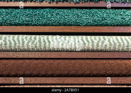 samples of multi-colored carpets on the shelves Stock Photo