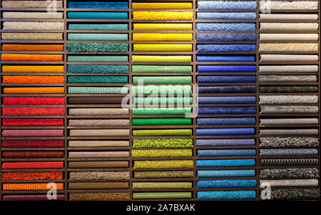 samples of multi-colored carpets on the shelves Stock Photo