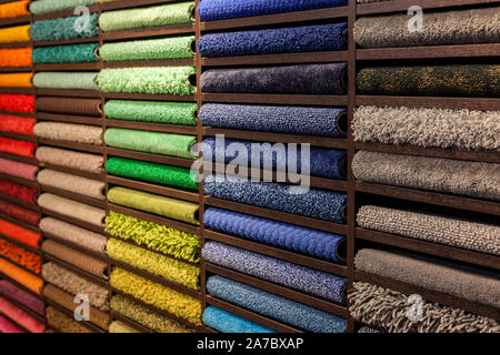 samples of multi-colored carpets on the shelves Stock Photo