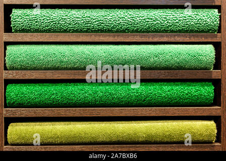 samples of multi-colored carpets on the shelves Stock Photo