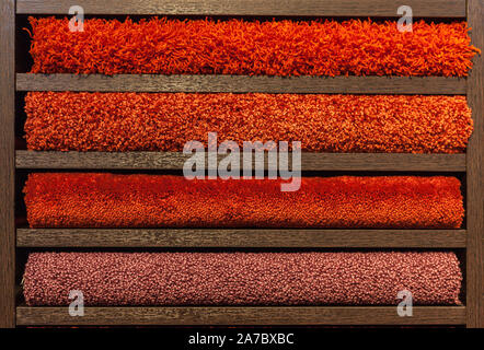samples of multi-colored carpets on the shelves Stock Photo