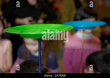 Fun with Spinning Plates .balancing a spinning plate. A collection of spinning purple plates . Stock Photo