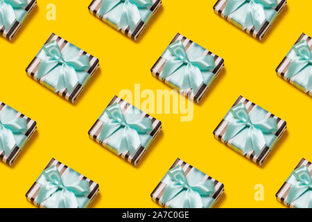 Pattern with stylish gift on a trendy orange background. Present for St. Valentine's day, engagements, Mother's Day, birthday, New Year, Christmas, holidays Stock Photo