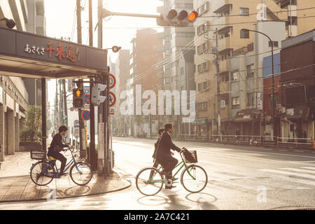 Tokyo, Japan - September 28, 2019 : local Japanese businessman biking on the bike to train station to go to work on Monday morning at the street of To Stock Photo