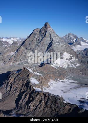 AERIAL VIEW from the east. 4478m-high Matterhorn / Cervino. Aosta Valley, italy (left of ridge) and Canton of Valais, Switzerland (right of ridge). Stock Photo