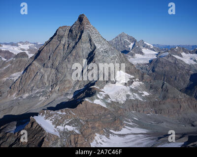 AERIAL VIEW from the east. 4478m-high Matterhorn / Cervino. Aosta Valley, italy (left of ridge) and Canton of Valais, Switzerland (right of ridge). Stock Photo