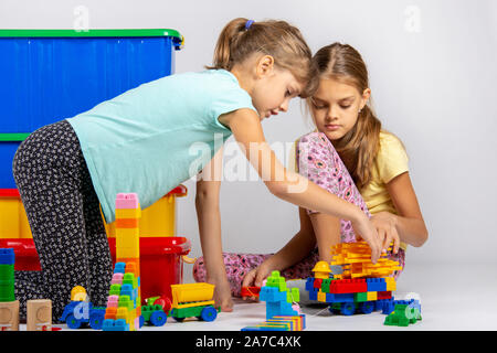 Two girls collect figures from the designer Stock Photo