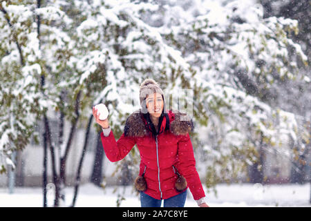 winter magic in the snow.Happy woman throwing snowball playing with snow on winter day. Stock Photo