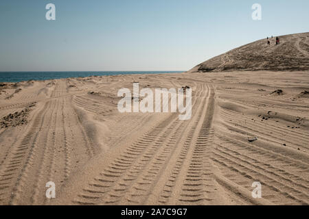 The Sealine beach south of Doha, Qatar is frequented by tourists and locals climbing dunes and dune bashing in vehicles. Stock Photo