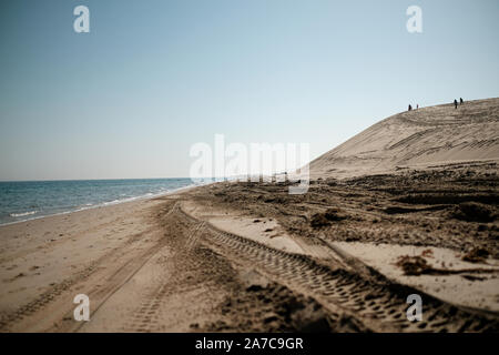 The Sealine beach south of Doha, Qatar is frequented by tourists and locals climbing dunes and dune bashing in vehicles. Stock Photo