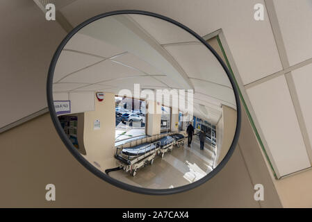 A round convex mirror in a hospital corridor. Stock Photo