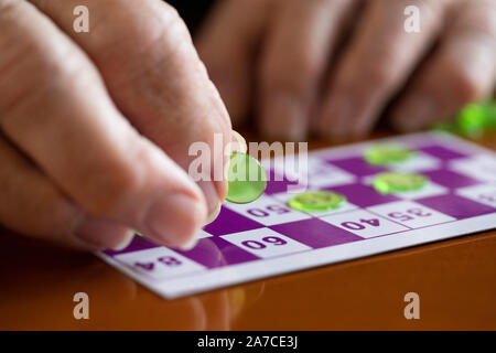 Close Up Of Senior Man Playing Game Of Bingo Stock Photo