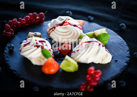 delicious pavlova sweet dish with fresh fruits & sugar syrup Stock Photo