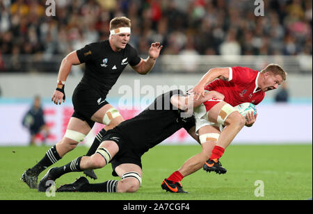 Wales' James Davis is tackled by New Zealand's Brodie Retallick during the 2019 Rugby World Cup bronze final match at Tokyo Stadium. Stock Photo