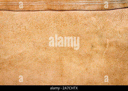 Genuine brown leather texture background. Abstract vintage natural cow skin backdrop. Wrong side of leather. Stock Photo