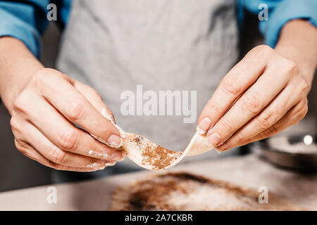 Making puff yeast dough with your hands - homemade sweet pastries Stock Photo