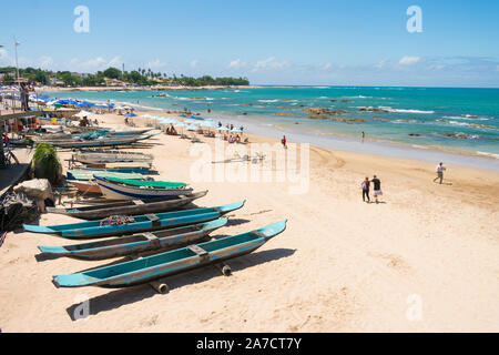 Salvador, Brazil - Circa September 2019: Canoes and small boats by the beach in Itapua on a sunny day Stock Photo