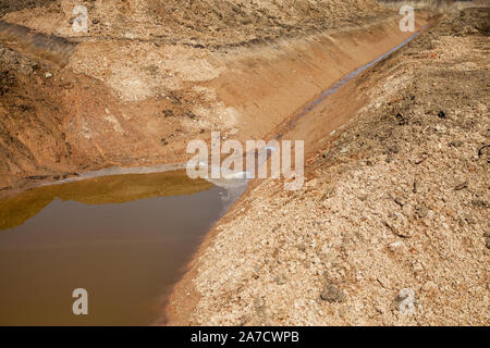 New water catchment canal for agriculture near fields. Stock Photo