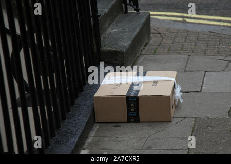 Amazon parcel delivery left on the street outside front door as homeowner not at home, 2019 Stock Photo