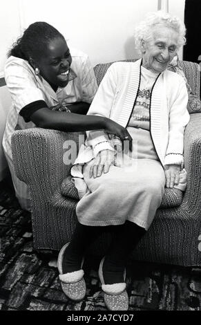 Care worker with elderly woman in residential care home, Nottingham, UK Jan 1989 Stock Photo