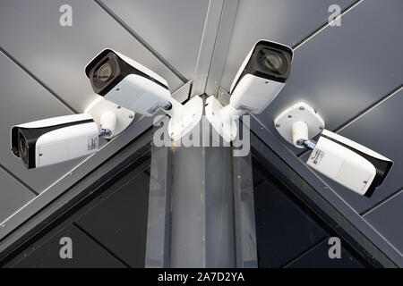 Bottom view close-up of four white surveillance cameras Stock Photo