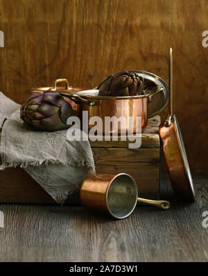 copper utensils, pots, ladle and pan on wooden background Stock Photo