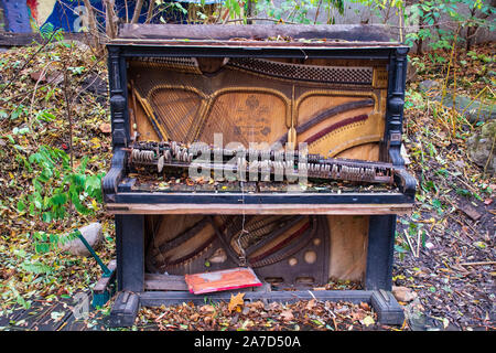 Old rotten abandoned grand piano Stock Photo