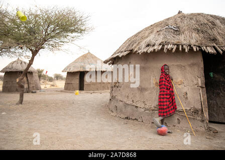 Arusha, Tanzania, 8th September 2019: maasai kid with a football outside his home Stock Photo