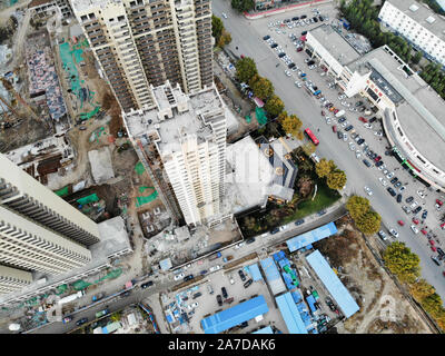 Aerial view of massive building sites in construction with tower crane. Building blocks apartment in construction in developing part of the city of Tianjin in China. Estate construction site. Stock Photo