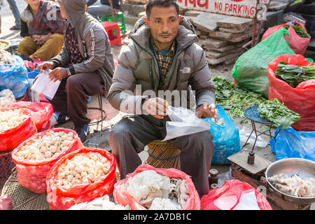 Kathmandu, Nepal - November 17, 2018: Man sells mushrooms at the street market in Kathmandu Stock Photo