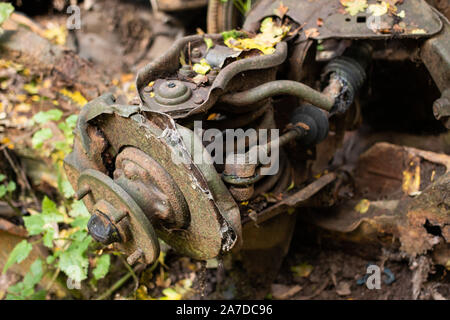 Debris from a rotting car sat along the side of the Coventry canal towpath in North Warwickshire Stock Photo