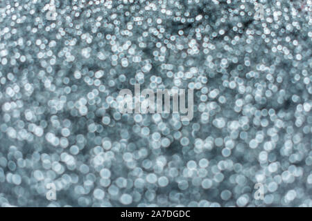Blurred silver shiny background of small sparkles. Stock Photo
