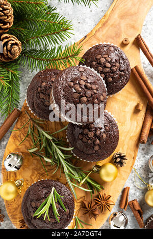 Christmas chocolate muffins. Xmas or New Year festive baking with decorations and fir tree Stock Photo