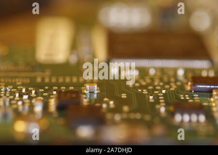 close up of a computer or electronic circuit board showing individual components as well as out of focus areas Stock Photo