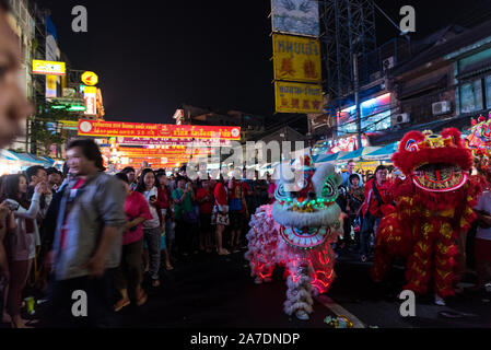 Two Chinese lions are out for a lion dance on Chinese New Year eve in Chinatown, in Bangkok, Thailand. Stock Photo