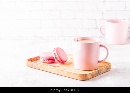 French macaroons and cup of coffee on a wooden tray. Stock Photo