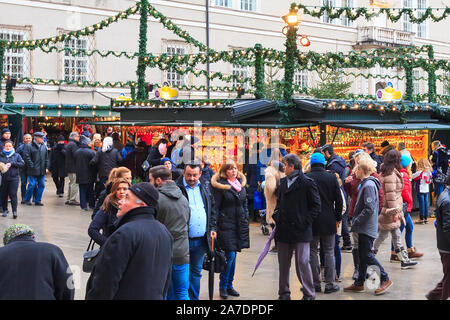 Salzburg, Austria - December 25, 2016: Christmas market with kiosks and stalls, people bying gifts Stock Photo