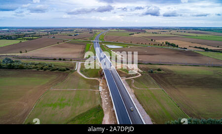 Picture dated October 10th 2019 shows a section of the new A14 near Huntingdon which part of the UKÕs biggest road upgrade and is to be opened a year early.   A new bypass on one of the UKÕs biggest road upgrades costing £1.5 billion is set to be open one year EARLY. The A14 Huntingdon bypass dual carriageway route in Cambridgeshire was not expected to be finished until late 2020, but drivers will be able to use it from this December. The Department for Transport says Highways England has made Òexcellent progressÓ and the 12-mile stretch will be opened ahead of schedule. The full 21-mile proje Stock Photo