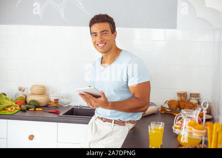 Cheerful brunette male looking straight at camera Stock Photo