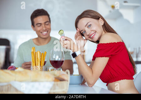 Cheerful young woman looking straight at camera Stock Photo