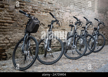 bicycles parked next to an old wall Stock Photo