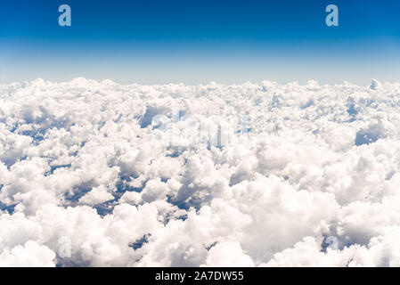 Abstract skyscape background with white cumulus clouds against blue sky. Stock Photo