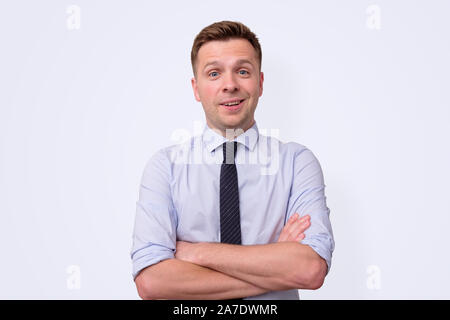 Handsome businessman with tie with folded hands. Studio shot Stock Photo