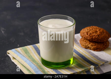 Turkish Drink Ayran or Kefir with oatmeal cookies on dark background, horizontal orientation, closeup Stock Photo
