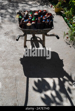 Wheelbarrow full of bottles of handmade wine and juice Stock Photo