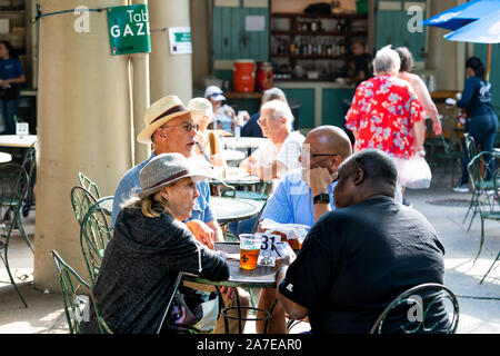 New Orleans, USA - April 23, 2018: People sitting eating cuisine food and beer at the Gazebo Cafe restaurant tables Stock Photo