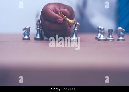 businessman holding and moving chess figure in competition success Stock Photo