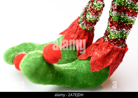Adorable plush pointy elf feet in red white and green pointy shoes with pom poms Stock Photo