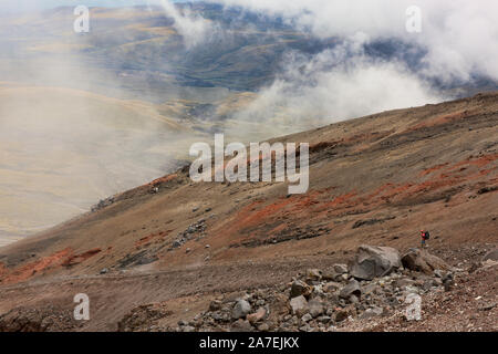 Climber descending from Jose Rivas refuge on Cotopaxi volcano, Cotopaxi National Park, Ecuador Stock Photo