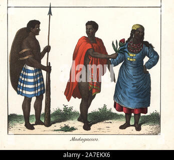 Malagasy people from Madagascar. Warrior with spear, club and wooden shield, man in cape offering a flower to a woman in dress with necklaces. Handcoloured lithograph from Friedrich Wilhelm Goedsche's 'Vollstaendige Völkergallerie in getreuen Abbildungen' (Complete Gallery of Peoples in True Pictures), Meissen, circa 1835-1840. Goedsche (1785-1863) was a German writer, bookseller and publisher in Meissen. Many of the illustrations were adapted from Bertuch's 'Bilderbuch fur Kinder' and others. Stock Photo